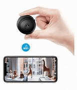 a hand is holding a small camera in front of a cell phone .