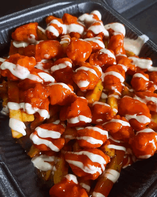 a tray of buffalo wings and fries with ranch dressing