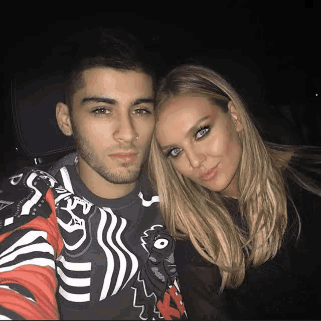 a man and a woman are sitting next to each other in a car and posing for a picture .