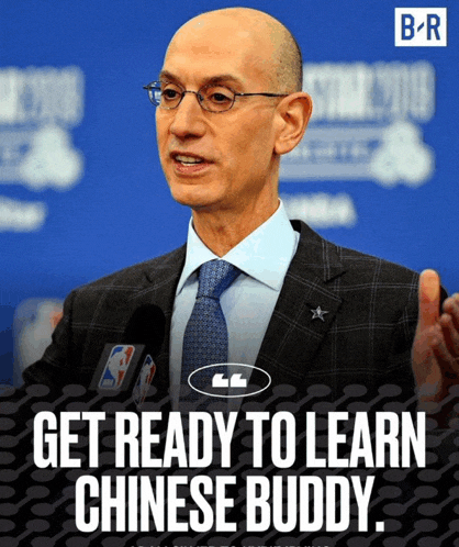 a man in a suit and tie is talking into a microphone with the words get ready to learn chinese buddy