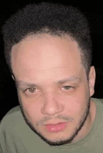 a close up of a man 's face with a beard