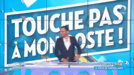 a man standing in front of a sign that says touche pas a mon poste