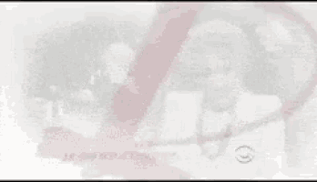 a man in a suit and tie is standing next to another man in a hat .