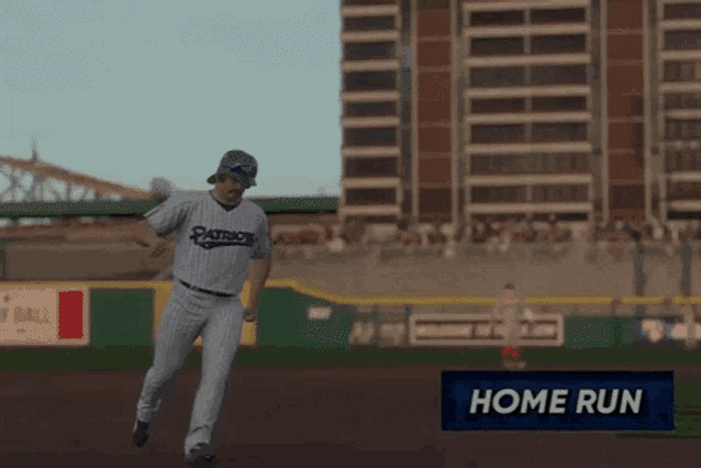 a patriots baseball player is running on a field