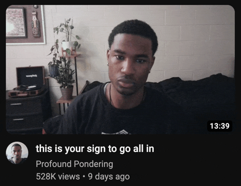 a man is sitting on a couch with a caption that says this is your sign to go all in