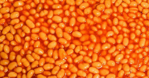 a close up of baked beans in tomato sauce