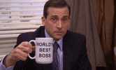 michael scott from the office is holding a mug that says `` world 's best boss '' .