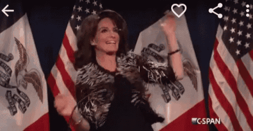 a woman is standing in front of american flags with a c span logo in the corner