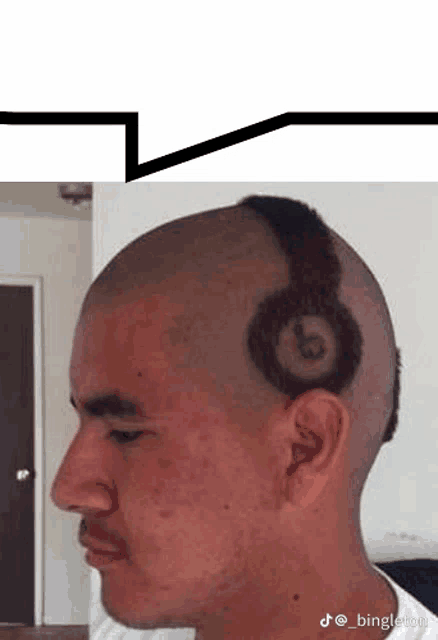 a man has a pair of beats headphones shaved into his head .