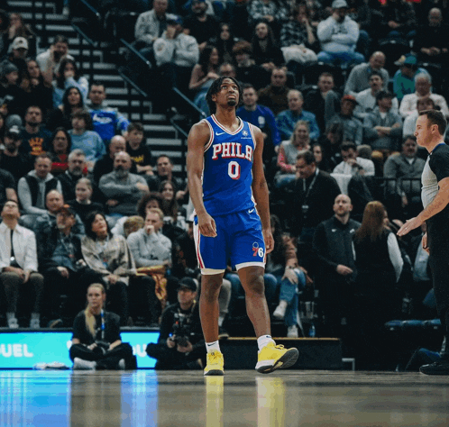 a philadelphia basketball player is standing on the court