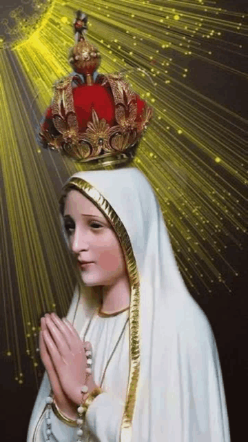 the virgin mary is wearing a crown on her head and praying .