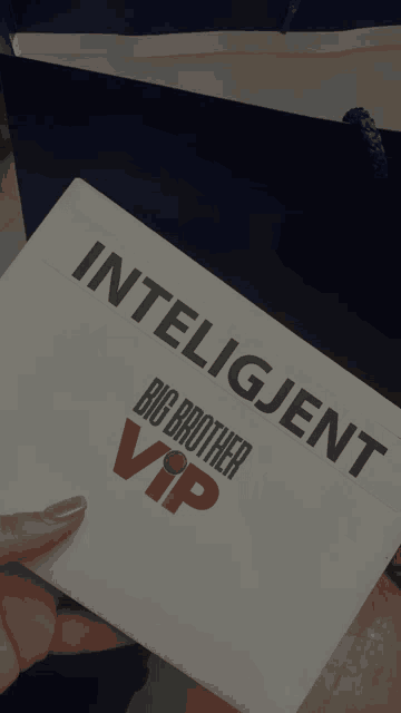 a person is holding an envelope that says " intelligent big brother vip "