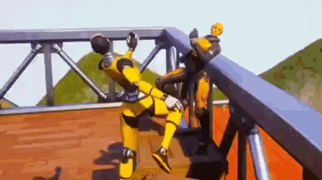 a couple of yellow robots are standing on top of a wooden platform on a bridge .