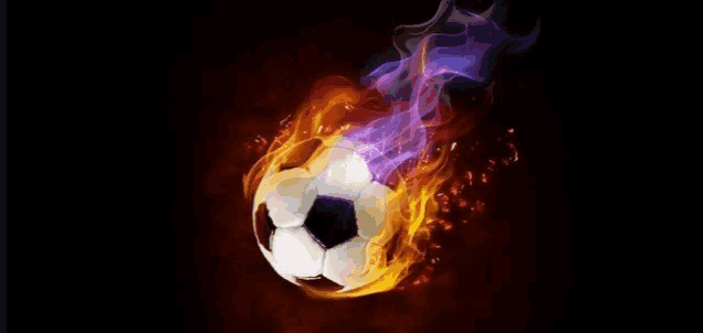 a soccer ball is surrounded by flames on a dark background