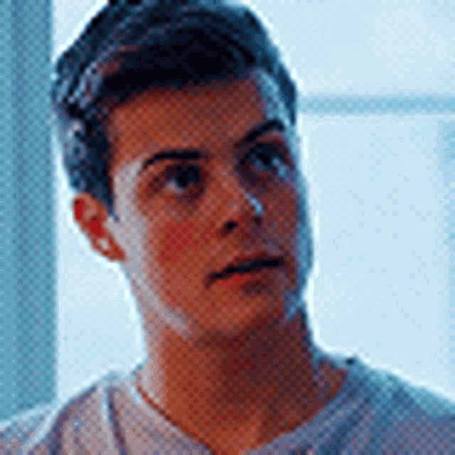 a close up of a young man 's face looking at the camera .