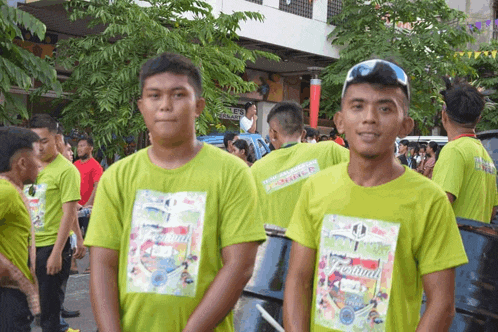 a group of men wearing green shirts that say festival on them