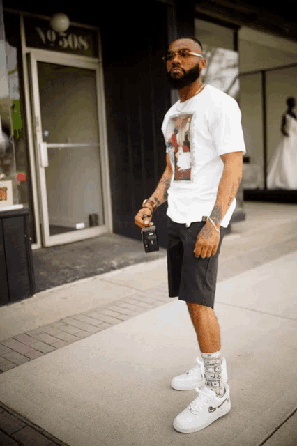 a man wearing a white t-shirt with a picture on it