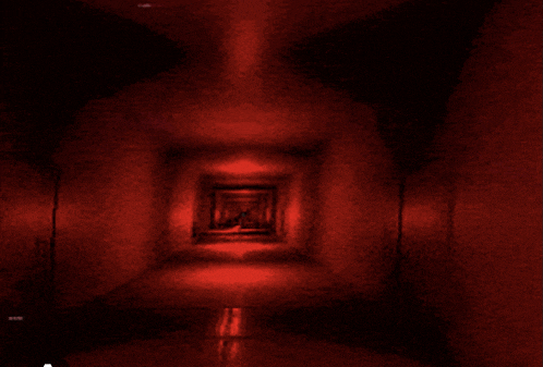 a dark hallway with red lights on the walls and floor