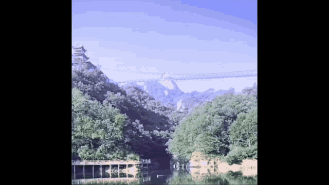 a bridge over a body of water with a castle in the background