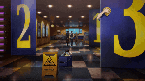 a yellow wet floor sign sits in front of a doorway