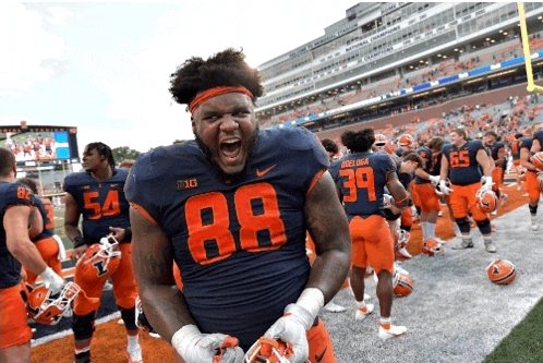 a football player with the number 88 on his jersey stands on the field