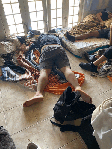 a person laying on the floor with a bag on the floor next to them