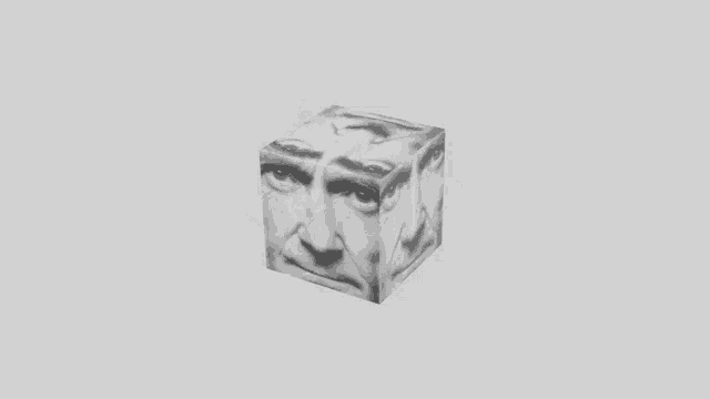 a black and white cube is floating in the air on a gray background .