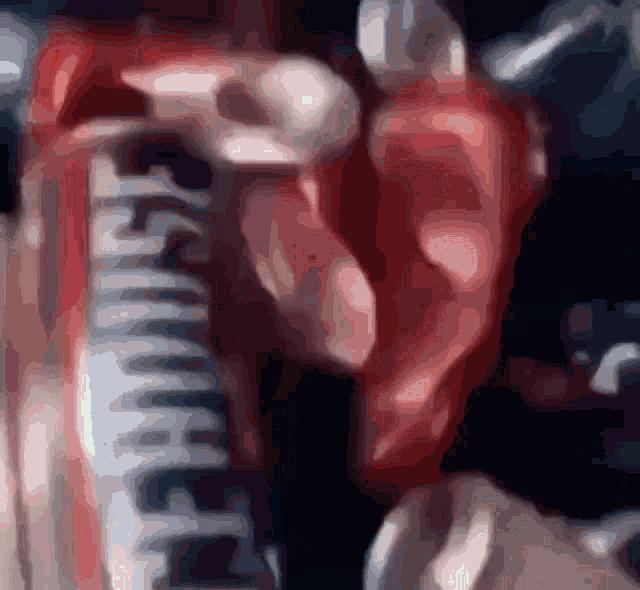 a blurry image of a person holding a can that says smirnoff