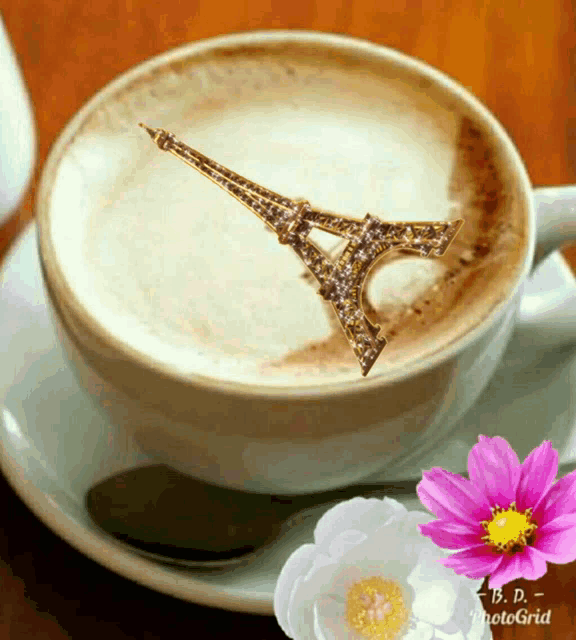 a cup of cappuccino with the eiffel tower drawn on it