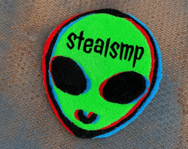 a green alien head with the words stealsmp written on it