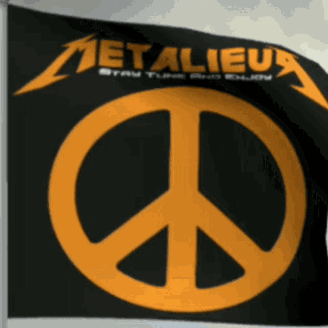 a metallica flag with a yellow peace sign on it