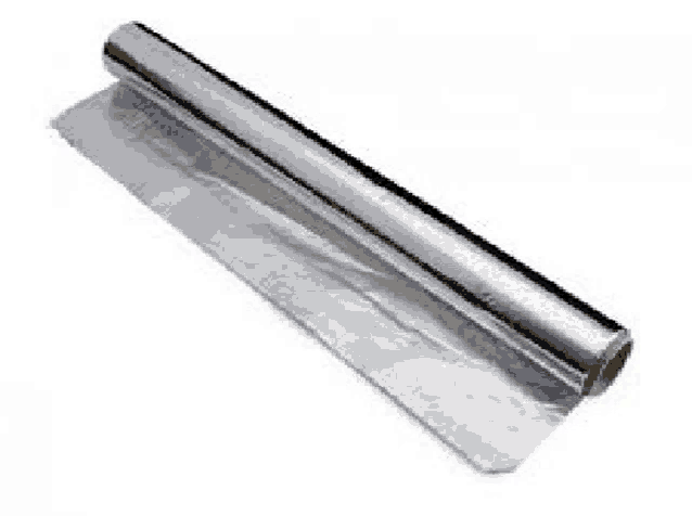 a roll of aluminum foil is sitting on top of a white surface .