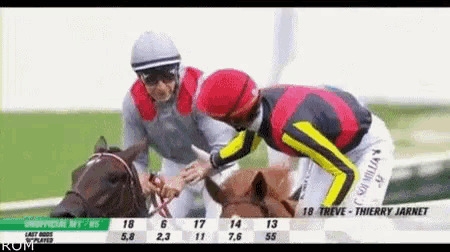 two jockeys are standing next to each other on a race track and one of them is wearing a shirt that says thierry jarnet