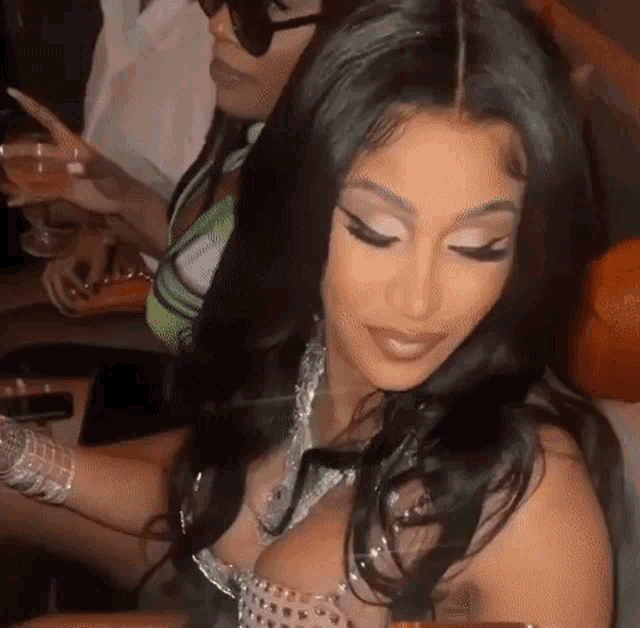 two women are sitting next to each other on a couch .