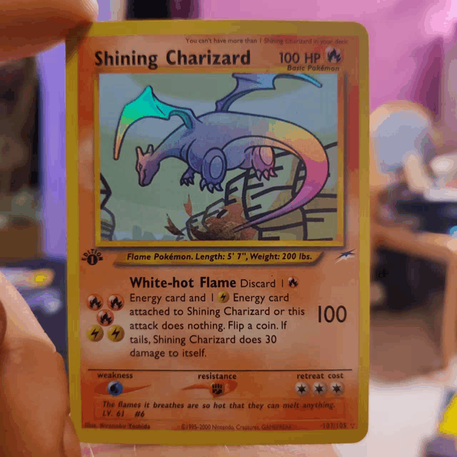 a shiny charizard pokemon card with a rainbow tail