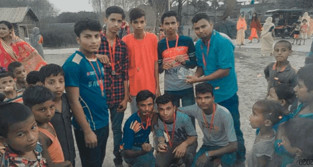 a group of young boys posing for a picture with one wearing a blue shirt that says samsung