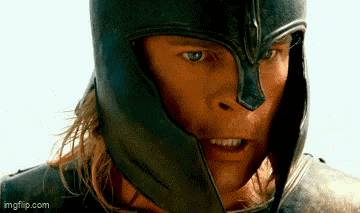 a close up of a man wearing a black helmet and armor .