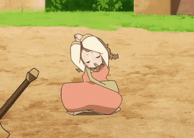 a girl in a pink dress is sitting on the ground