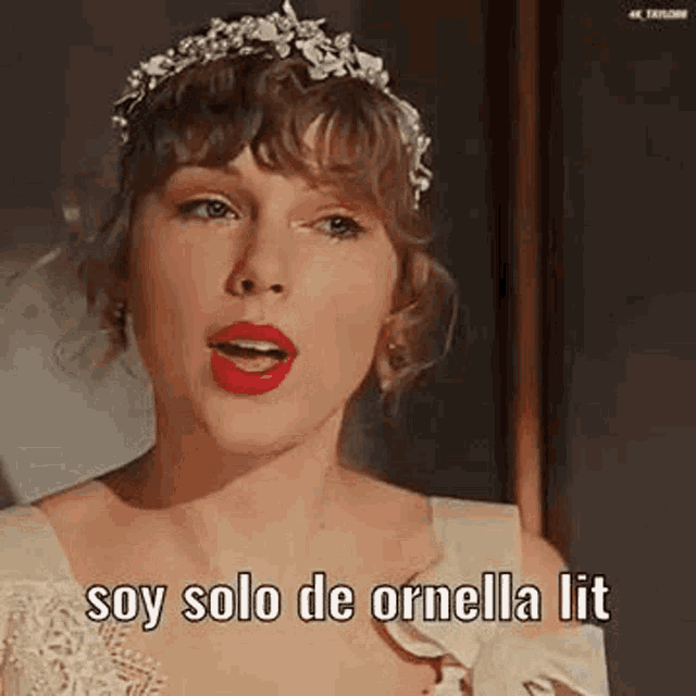 taylor swift is wearing a white dress and a flower crown while singing .