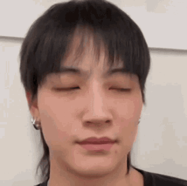 a close up of a person with their eyes closed .