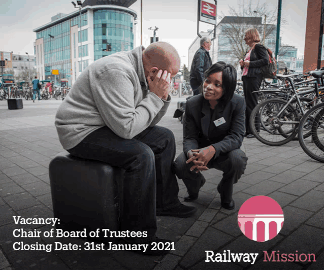 an advertisement for the railway mission shows a man sitting on a suitcase and a woman kneeling next to him