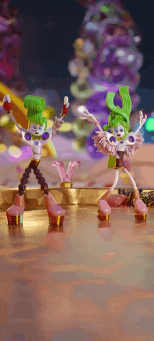 a couple of dolls with green hair are dancing