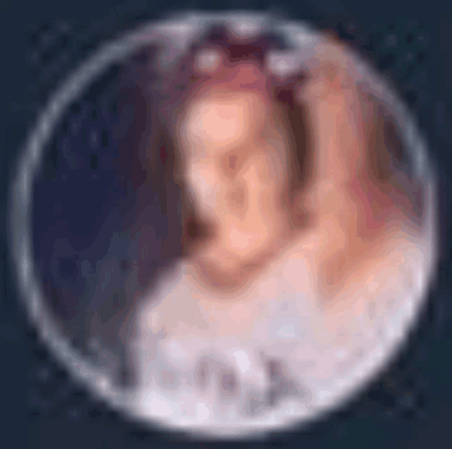 a blurry picture of a woman 's face in a circle .