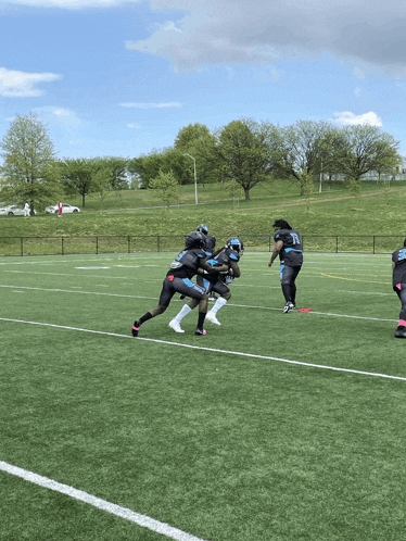 a group of football players on a field one of whom is wearing a jersey with the number 23 on it