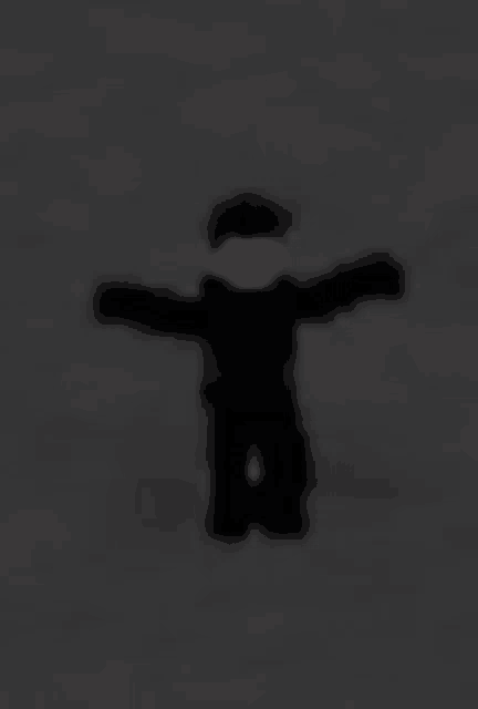 a blurry picture of a roblox character with his arms outstretched in the dark .