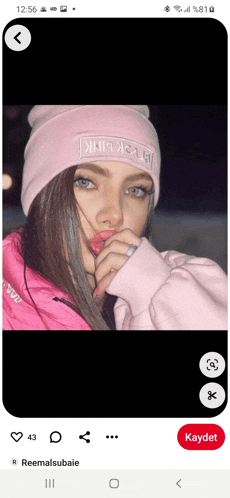 a picture of a girl wearing a pink beanie with black pink written on it