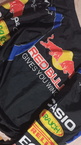 a black shirt with red bull written on it