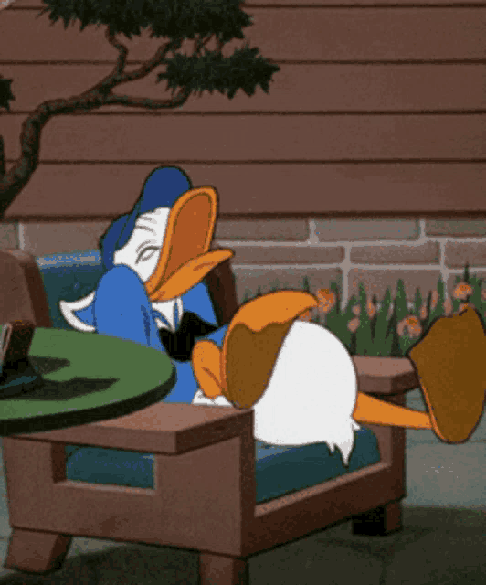 a cartoon of donald duck laying on a chair with his feet up