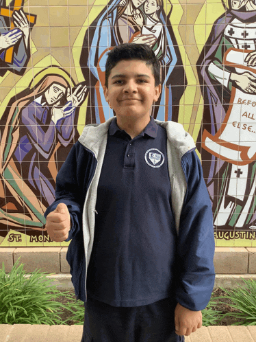 a boy in front of a mural that says st. mon