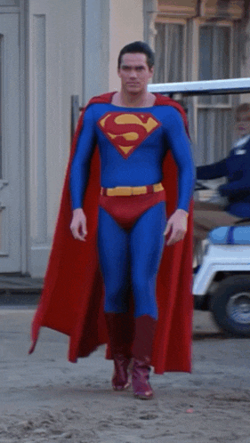 a man in a superman costume with a red cape
